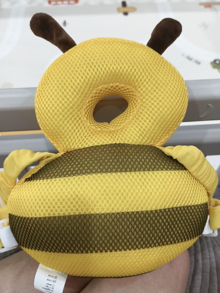 Close-up customer photo of the Buzzy Bee cushion